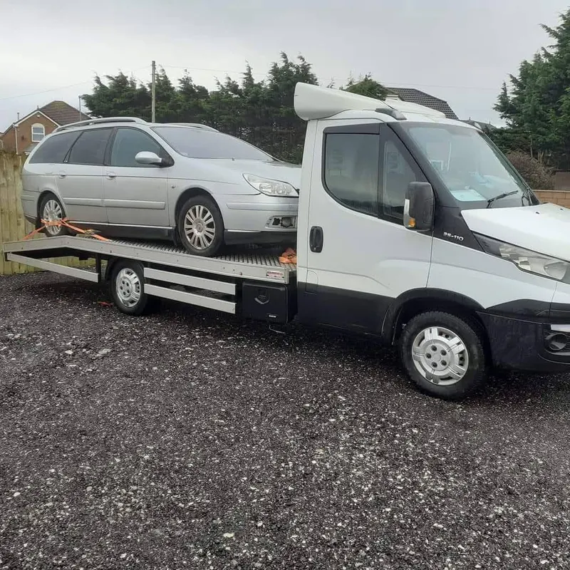 Estate car on recovery truck for scrap